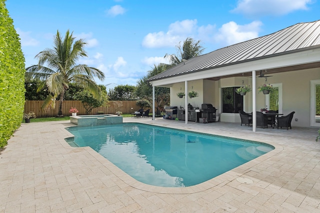 view of swimming pool featuring a patio area, ceiling fan, an in ground hot tub, and area for grilling