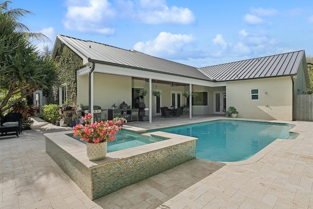 view of pool with ceiling fan, a patio, a grill, and area for grilling