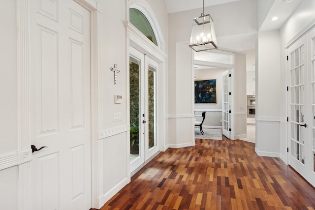 foyer with french doors and dark hardwood / wood-style floors