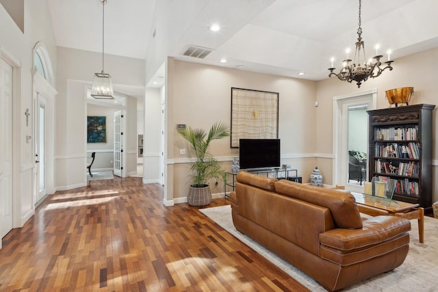 living room featuring a chandelier and hardwood / wood-style floors