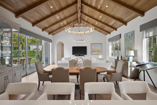 dining room featuring beamed ceiling, wood ceiling, high vaulted ceiling, and an inviting chandelier