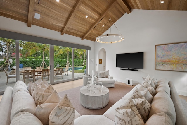 living room featuring beamed ceiling, high vaulted ceiling, a notable chandelier, and wood ceiling