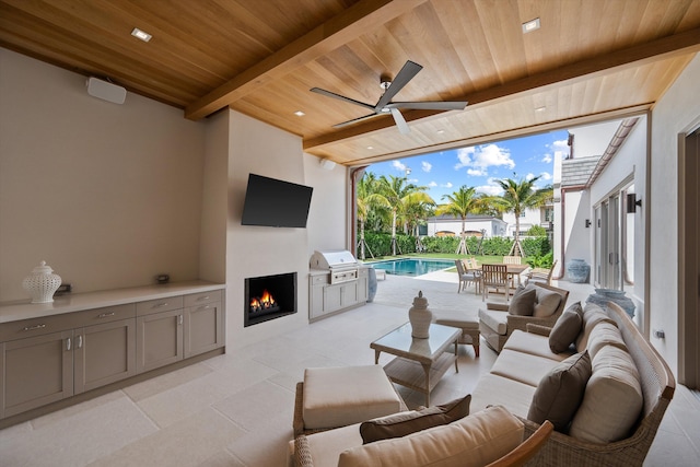 view of patio with outdoor lounge area, an outdoor kitchen, ceiling fan, and a grill