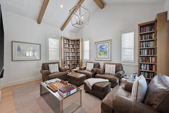 living room with vaulted ceiling with beams, light hardwood / wood-style flooring, a chandelier, and plenty of natural light