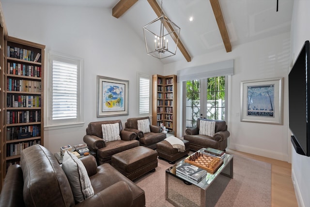 living room with light wood-type flooring, vaulted ceiling with beams, plenty of natural light, and a notable chandelier