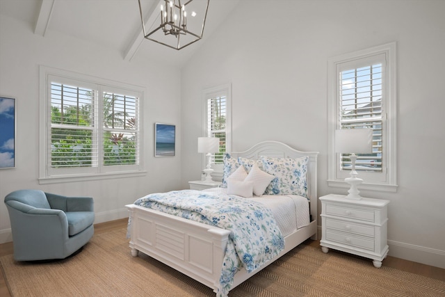 bedroom featuring beam ceiling, high vaulted ceiling, and a notable chandelier