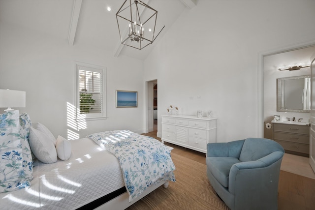 bedroom featuring high vaulted ceiling, an inviting chandelier, ensuite bathroom, beam ceiling, and wood-type flooring