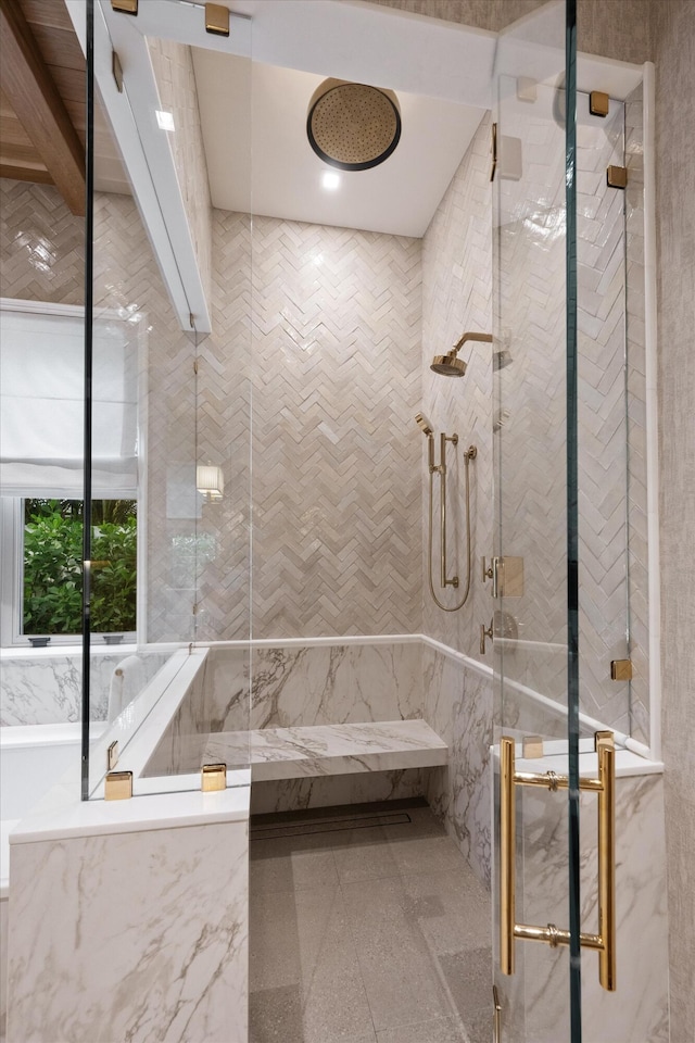 bathroom featuring a shower with door and tile walls