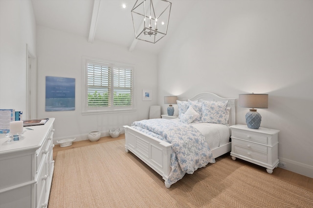 bedroom featuring lofted ceiling with beams, light hardwood / wood-style floors, and a notable chandelier