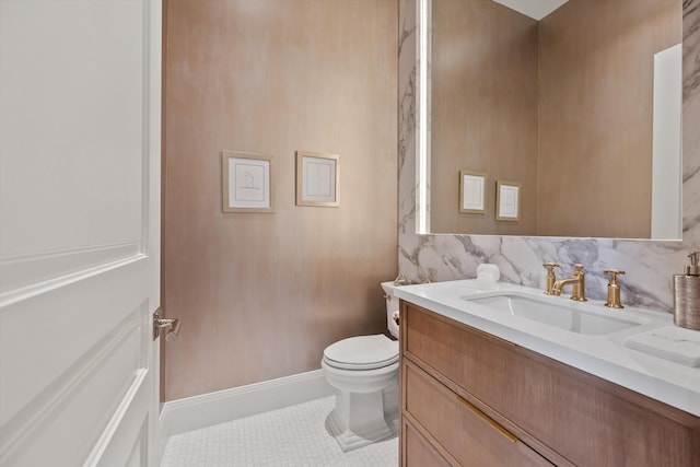 bathroom featuring tile patterned flooring, vanity, and toilet