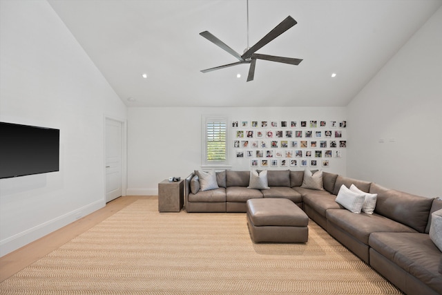 living room with light hardwood / wood-style floors and vaulted ceiling