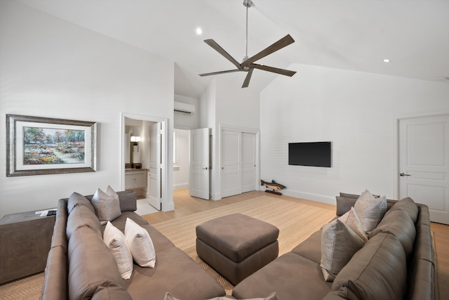 living room featuring an AC wall unit, ceiling fan, high vaulted ceiling, and light hardwood / wood-style floors