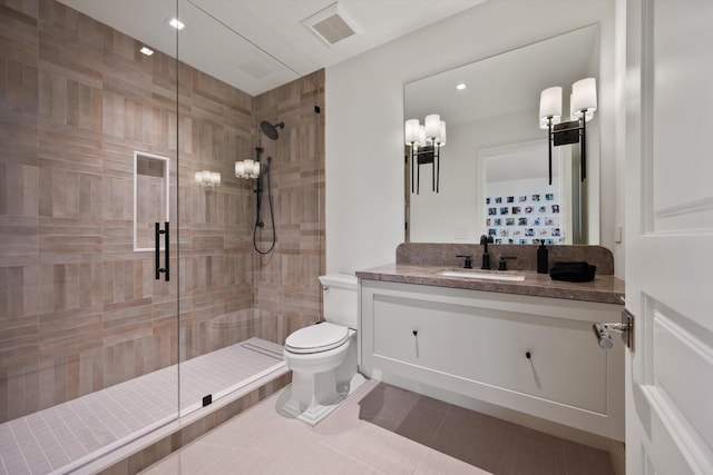 bathroom with tile patterned floors, vanity, toilet, and an enclosed shower