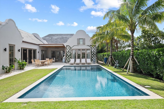 rear view of house with a yard, a patio, and ceiling fan