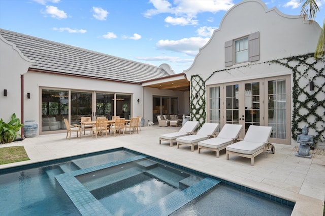 rear view of property with a pool with hot tub, a patio area, and an outdoor hangout area