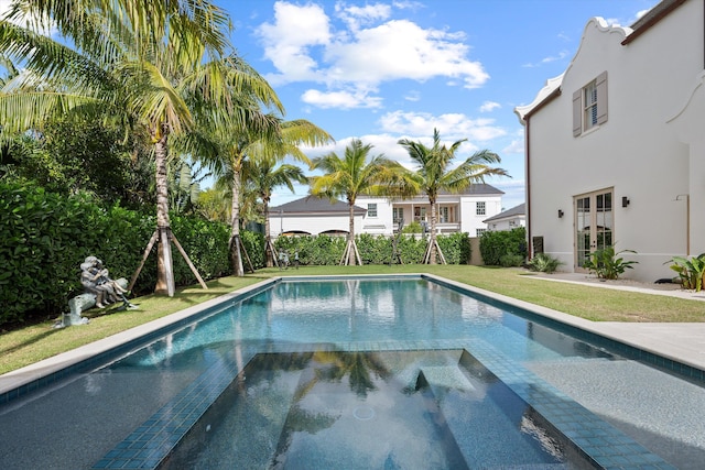 view of pool featuring an in ground hot tub and a lawn