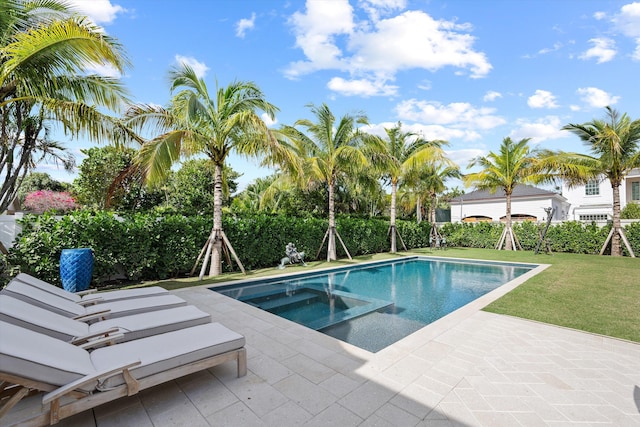 view of pool featuring an in ground hot tub, a patio, and a lawn