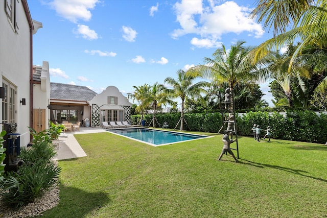 view of pool featuring a lawn and a patio area