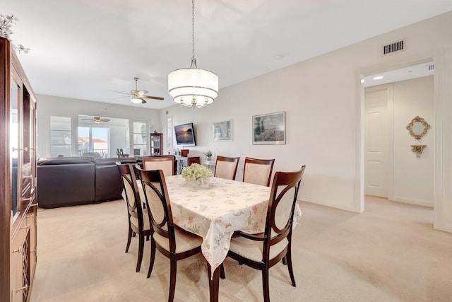 1 Harbour Isle Dr E Unit Ph2, Hutchinson Island, FL 34949 - dining area with light carpet, ceiling fan, and a chandelier