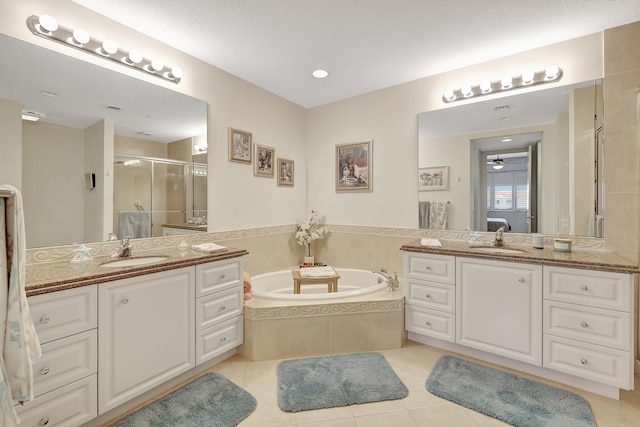 1 Harbour Isle Dr E Unit Ph2, Hutchinson Island, FL 34949 - full bathroom featuring a shower stall, a bath, two vanities, and tile patterned flooring