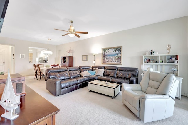 carpeted living room featuring ceiling fan