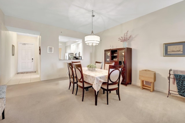 1 Harbour Isle Dr E Unit Ph2, Hutchinson Island, FL 34949 - dining space with light colored carpet, baseboards, and a chandelier