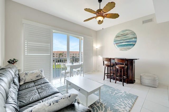 1 Harbour Isle Dr E Unit Ph2, Hutchinson Island, FL 34949 - living room featuring a ceiling fan, light tile patterned floors, baseboards, and a dry bar