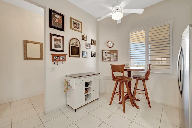1 Harbour Isle Dr E Unit Ph2, Hutchinson Island, FL 34949 - dining room featuring ceiling fan, baseboards, and light tile patterned flooring