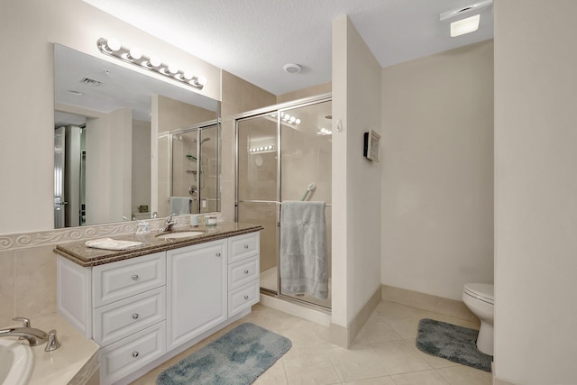 full bathroom with a textured ceiling, tile patterned floors, vanity, toilet, and plus walk in shower