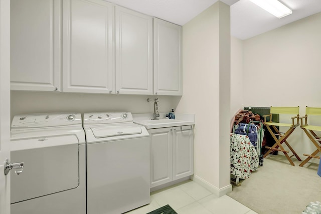 laundry room featuring cabinets, sink, and washing machine and clothes dryer