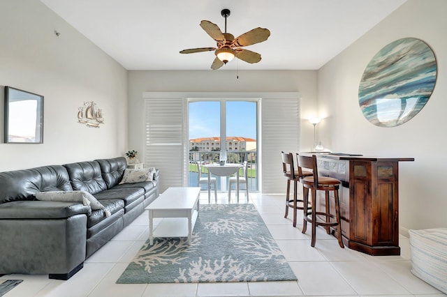 living room with ceiling fan and light tile patterned flooring