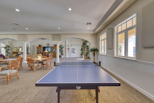 recreation room featuring decorative columns, light carpet, and ornamental molding