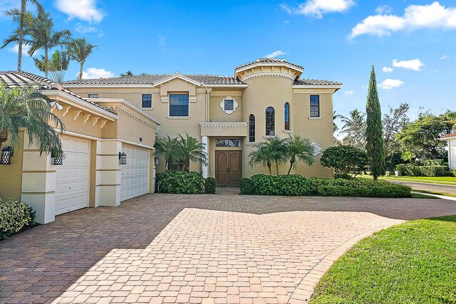 mediterranean / spanish house featuring a garage