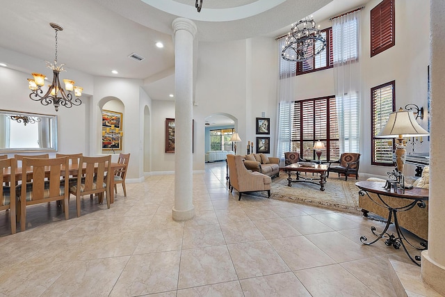 living area featuring an inviting chandelier, plenty of natural light, visible vents, and tile patterned floors