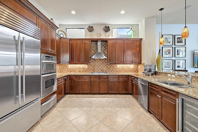 kitchen with beverage cooler, stainless steel appliances, a sink, light stone countertops, and wall chimney exhaust hood