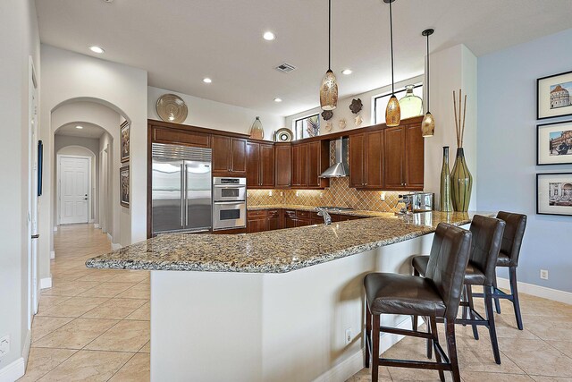 tiled living room with an inviting chandelier