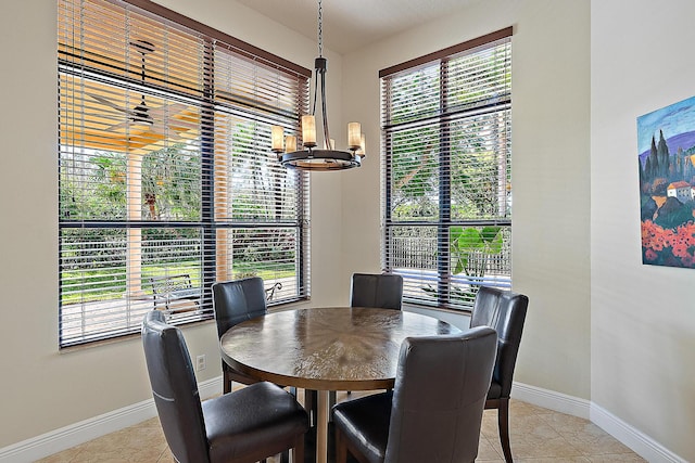 dining room with an inviting chandelier, baseboards, and light tile patterned floors