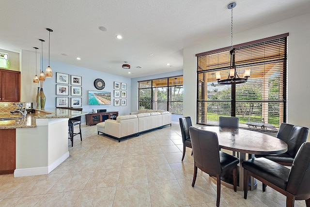 dining area featuring light tile patterned floors, baseboards, a chandelier, and recessed lighting