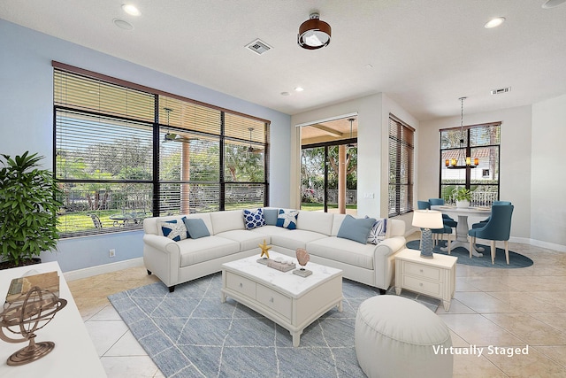 living area featuring light tile patterned floors, a wealth of natural light, and visible vents