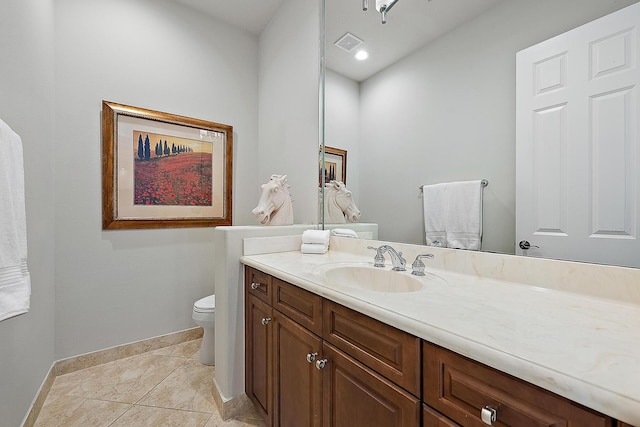 half bathroom featuring baseboards, visible vents, toilet, tile patterned floors, and vanity