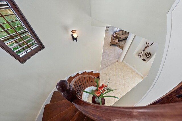 bedroom with light hardwood / wood-style floors and a raised ceiling