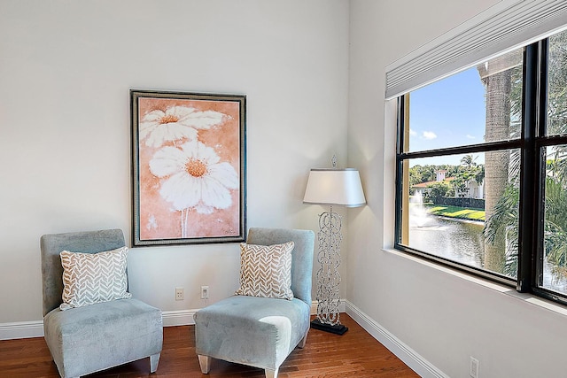 living area with wood finished floors and baseboards