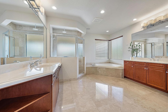 bathroom with a garden tub, a shower stall, visible vents, and a sink