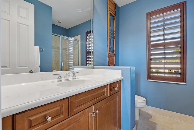 bathroom featuring baseboards, toilet, tile patterned floors, vanity, and a shower stall