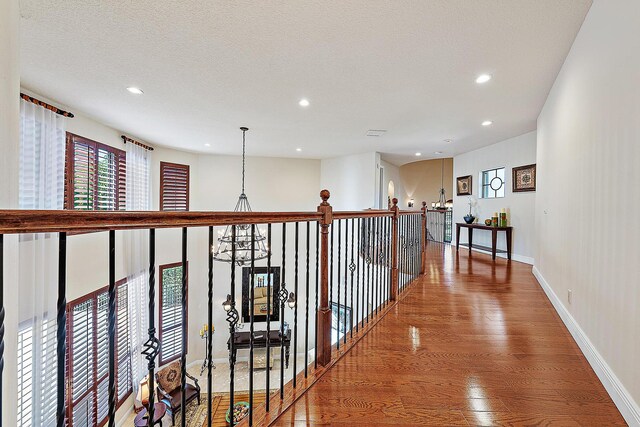 bedroom featuring ceiling fan, light hardwood / wood-style floors, and a textured ceiling