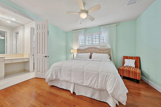 full bathroom featuring toilet, vanity, tiled shower / bath combo, ceiling fan, and tile patterned flooring