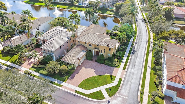 drone / aerial view with a water view and a residential view