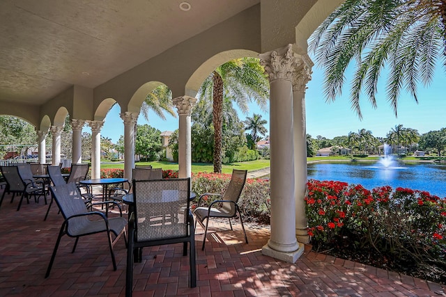 view of patio / terrace featuring outdoor dining space and a water view