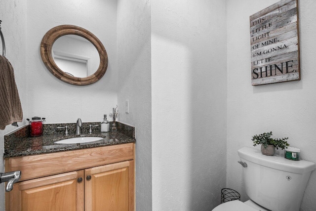 bathroom featuring toilet and vanity