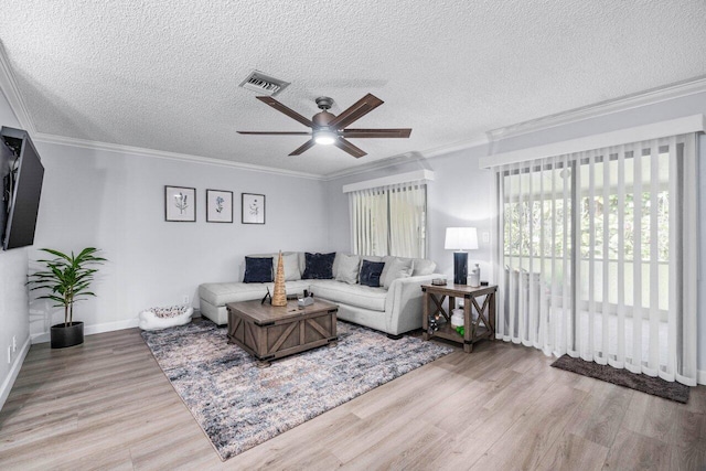 living room featuring a textured ceiling, ceiling fan, crown molding, and light hardwood / wood-style floors